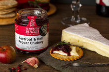 Load image into Gallery viewer, An open jar of Cumbrian Delights Beetroot and Bell Pepper Chutney, on a table next to a wedge of brie and a cracker with both brie and chutney on top